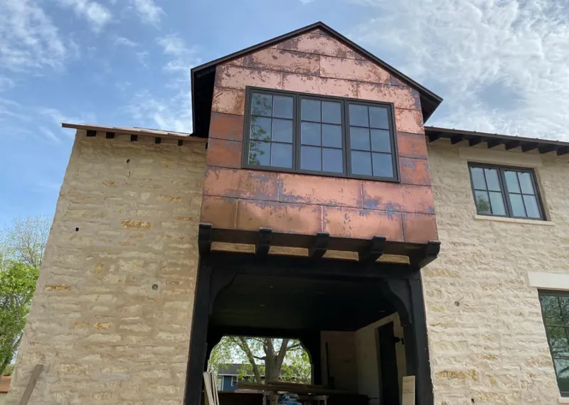 Copper metal panel facade on a stone building for Skylight Installation in West Jefferson